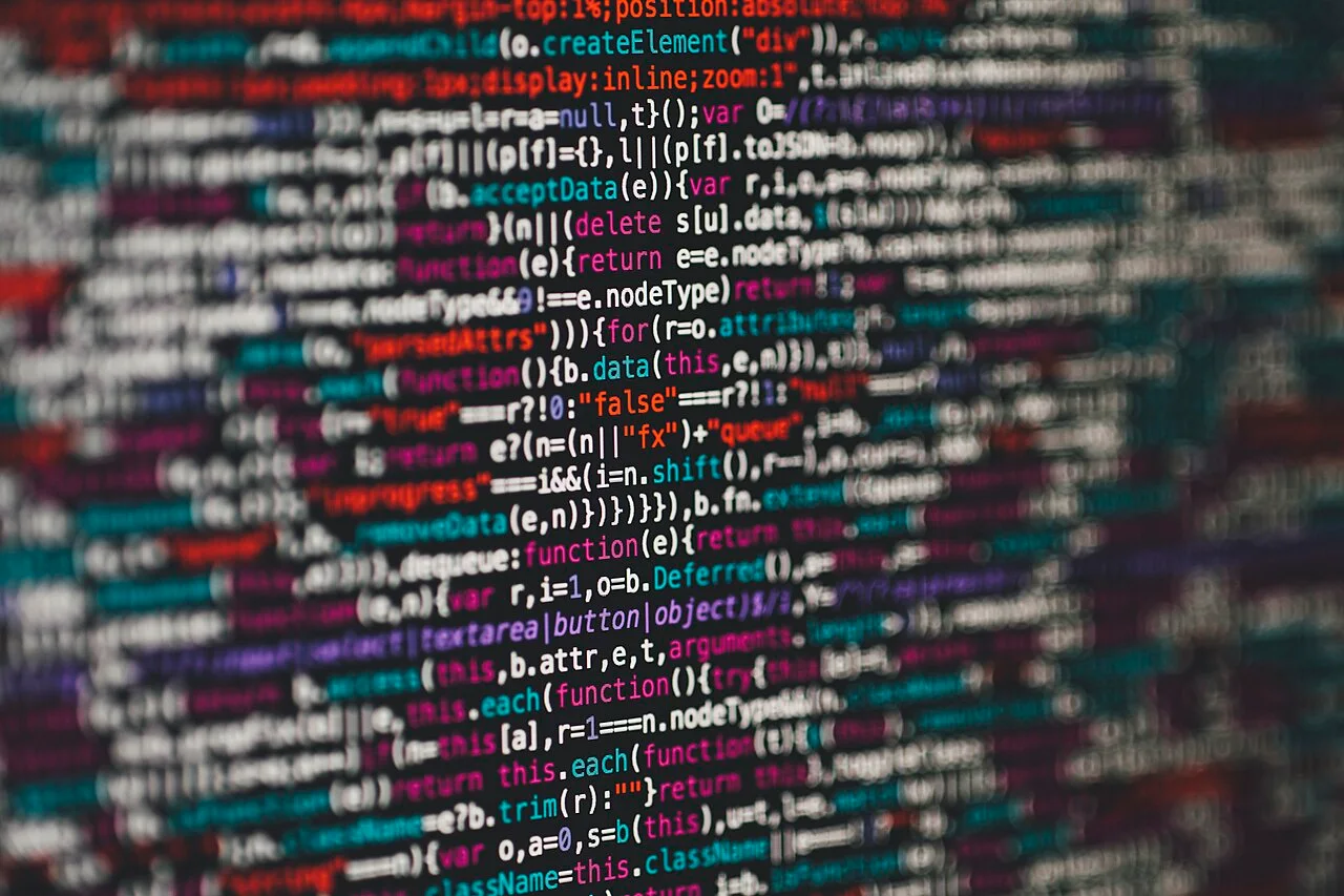 Close-up of programming code on a screen, with colour highlighting and selective focus.